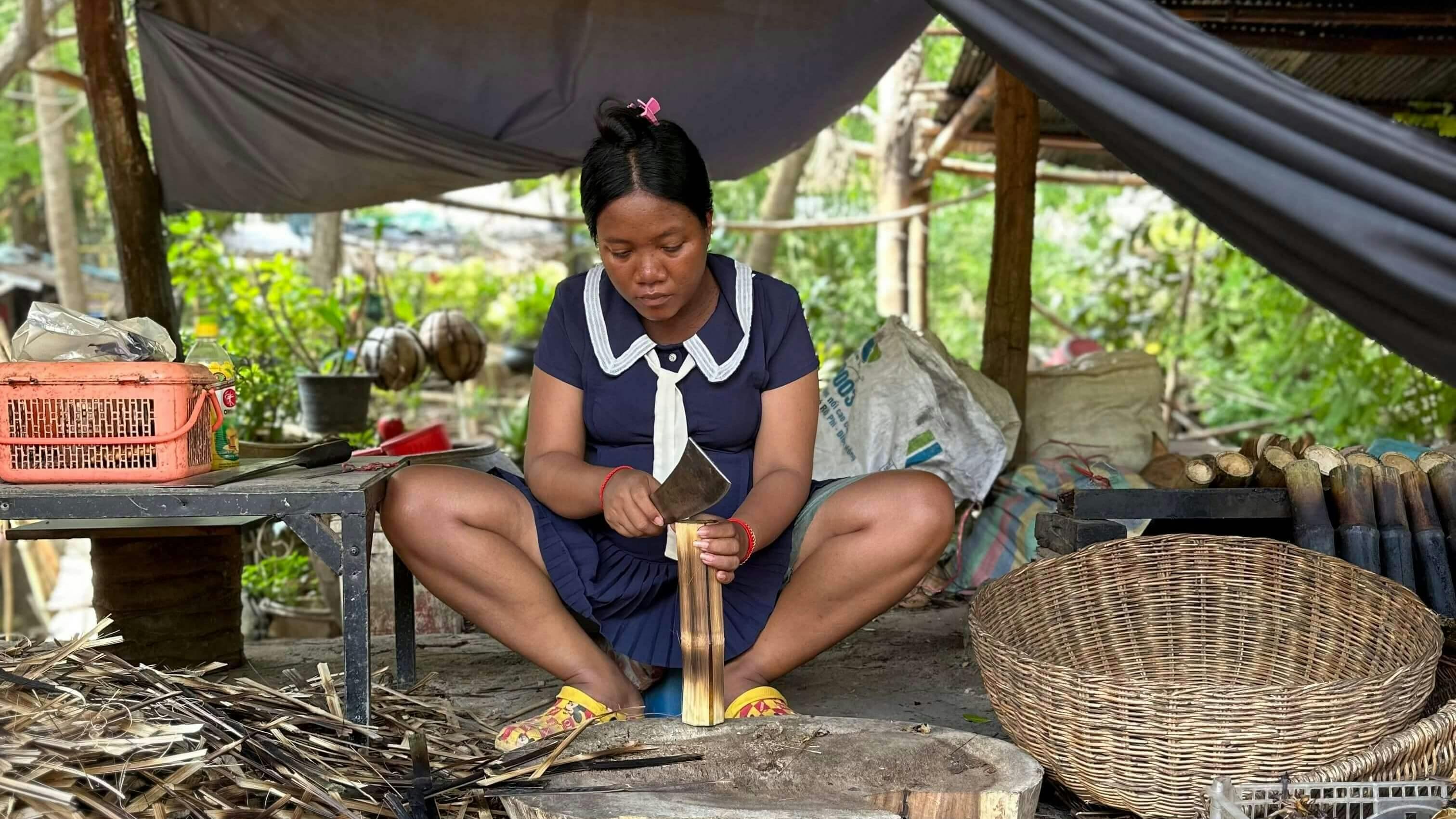 A woman cutting a coconut shoot in Battambang, Cambodia